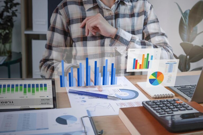 Homem analisando gráficos de desempenho de negócios e dados financeiros, focando em métricas como churn e ROI, usando tecnologia digital em um ambiente de escritório.