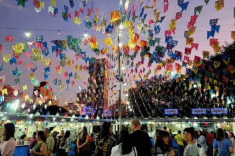 Imagem de uma feira de festas juninas em São Paulo com bandeirinhas coloridas penduradas, iluminação decorativa e pessoas curtindo a celebração das 15 Quermesses em São Paulo.