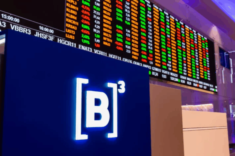 Tela de indicadores do mercado de ações em uma bolsa de valores, com números coloridos em neon vermelho, verde e amarelo e painel digital exibindo dados financeiros.