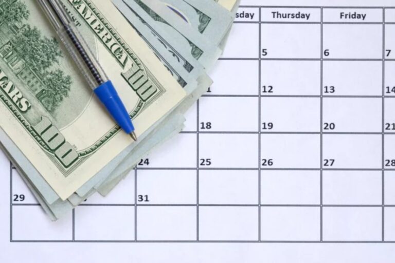 Planejamento financeiro usando calendário, dinheiro em notas de dólar e caneta