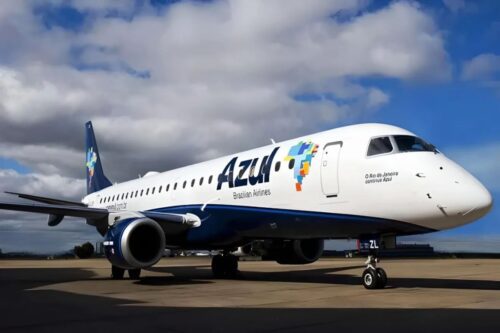 A imagem mostra uma aeronave, provavelmente um Embraer 190 ou 195, no pátio de um aeroporto, identificada pelas cores e logotipos da Azul Linhas Aéreas Brasileiras.