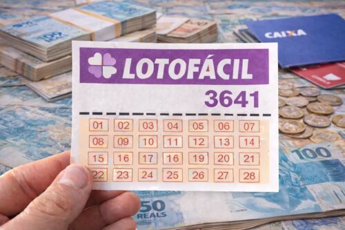 Bilhete da Lotofácil 3641 em destaque sobre notas e moedas de real