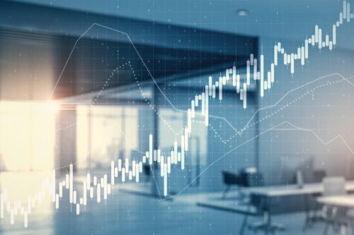 Empresário analisando gráfico de ações na tela, refletindo sobre investimentos de FIIs.