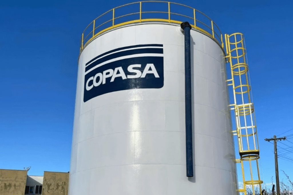 Vista frontal de um tanque industrial branco com a marca Copasa, com tubulação.