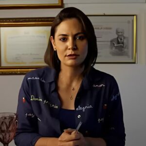 Michelle Bolsonaro sentada em escritório diante de certificados na parede durante pronunciamento em vídeo sobre política.