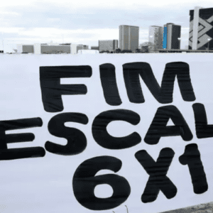 Uma faixa branca estendida horizontalmente exibe a frase "FIM ESCALA 6X1" escrita em grandes letras pretas e maiúsculas. Ao fundo, sob um céu nublado, é possível ver uma área aberta com prédios urbanos e a arquitetura característica de Brasília, incluindo o edifício do Banco do Brasil.